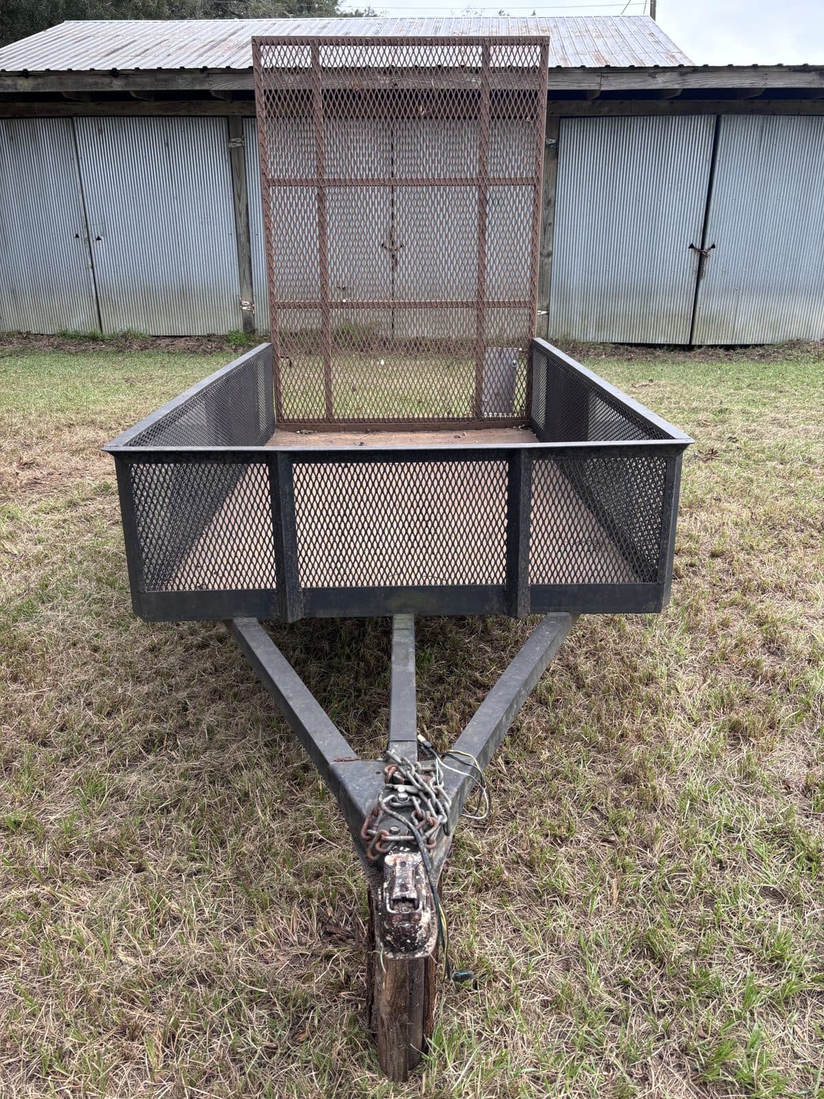 Front view of the 4 × 8 utility trailer looking down the tongue with the rear ramp gate raised