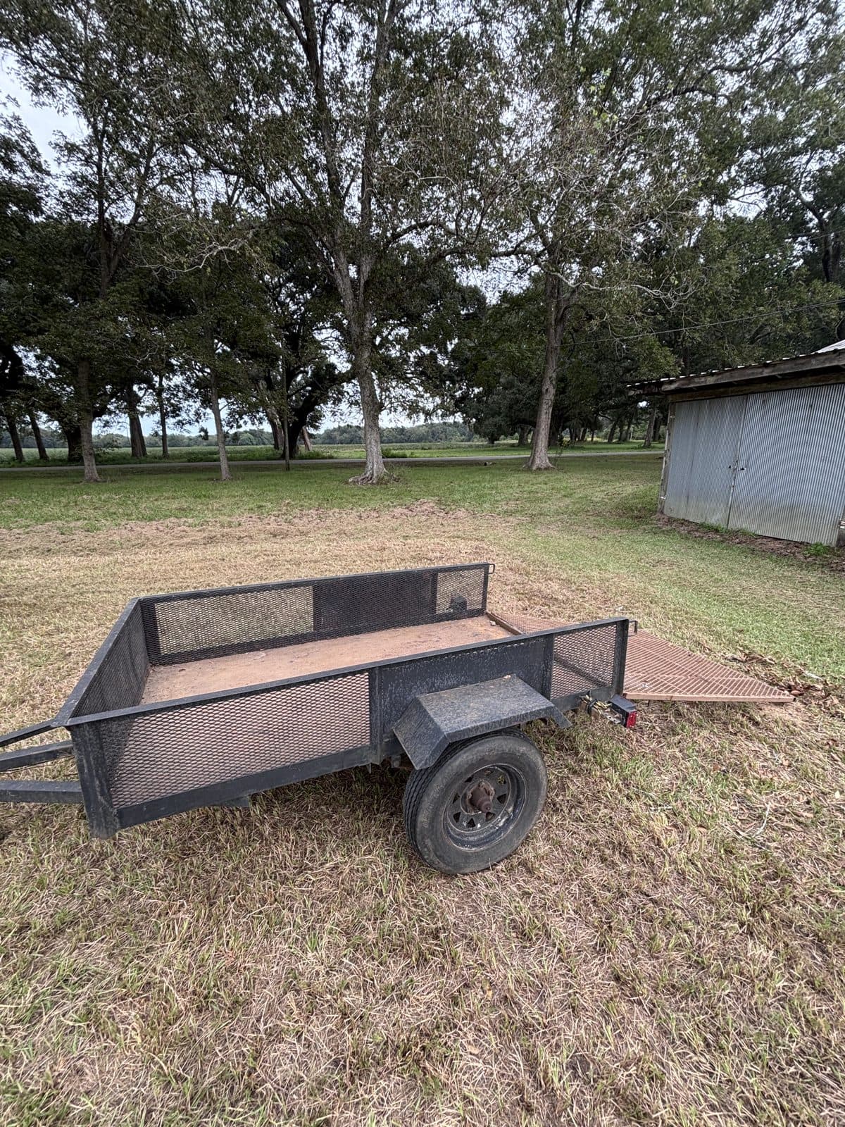 Side view of the 4 × 8 utility trailer with the rear ramp lowered