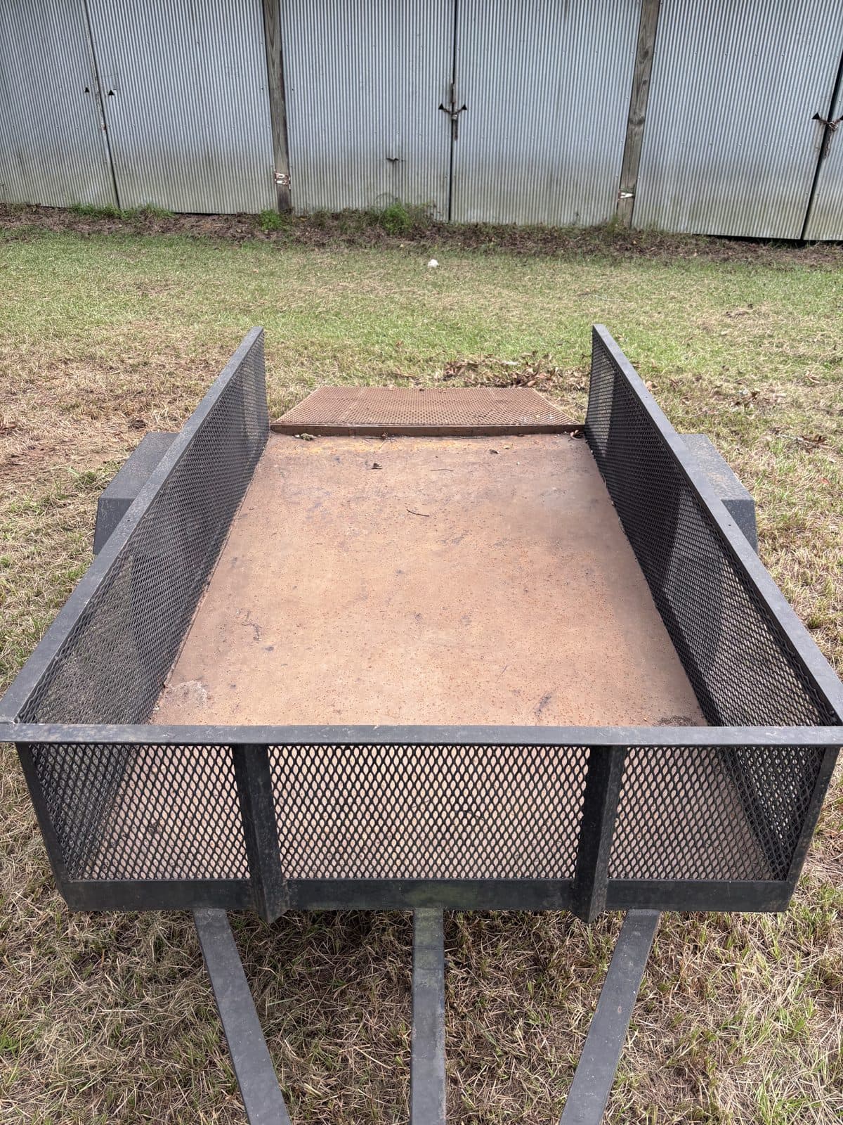 Top-down view of the 4 × 8 utility trailer deck from the tongue end