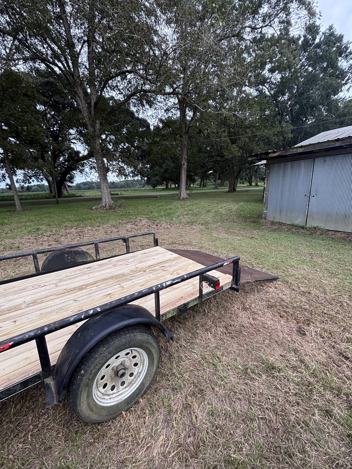 Rear three-quarter view of the 6 × 12 utility trailer with the ramp lowered